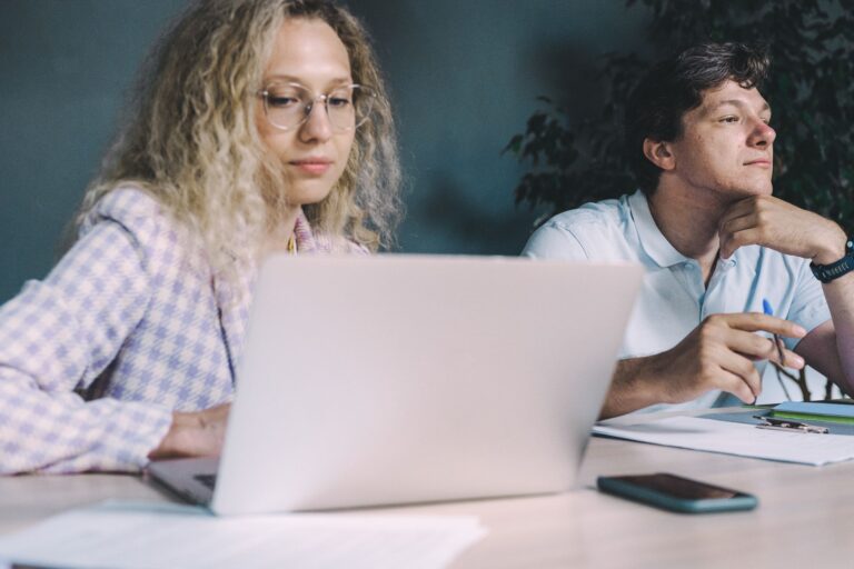 Coworkers discussing laptop