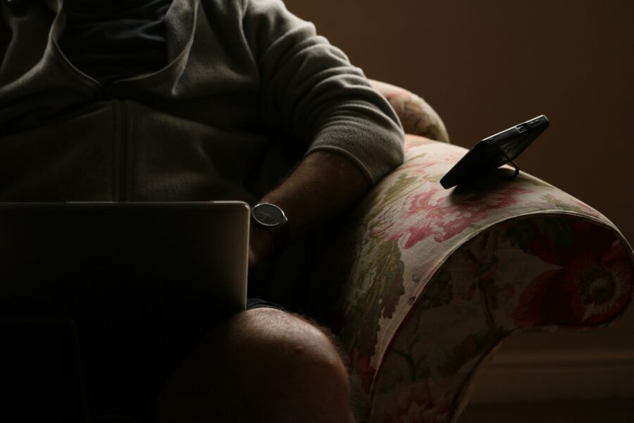 Person phone laptop