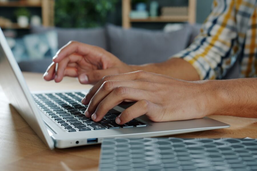Person typing laptop